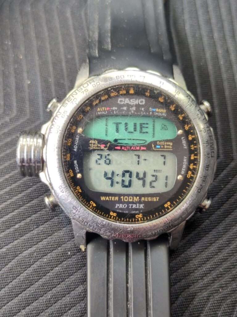 Dusty Casio Pro Trek digital watch face showing altimeter data and TUE day display