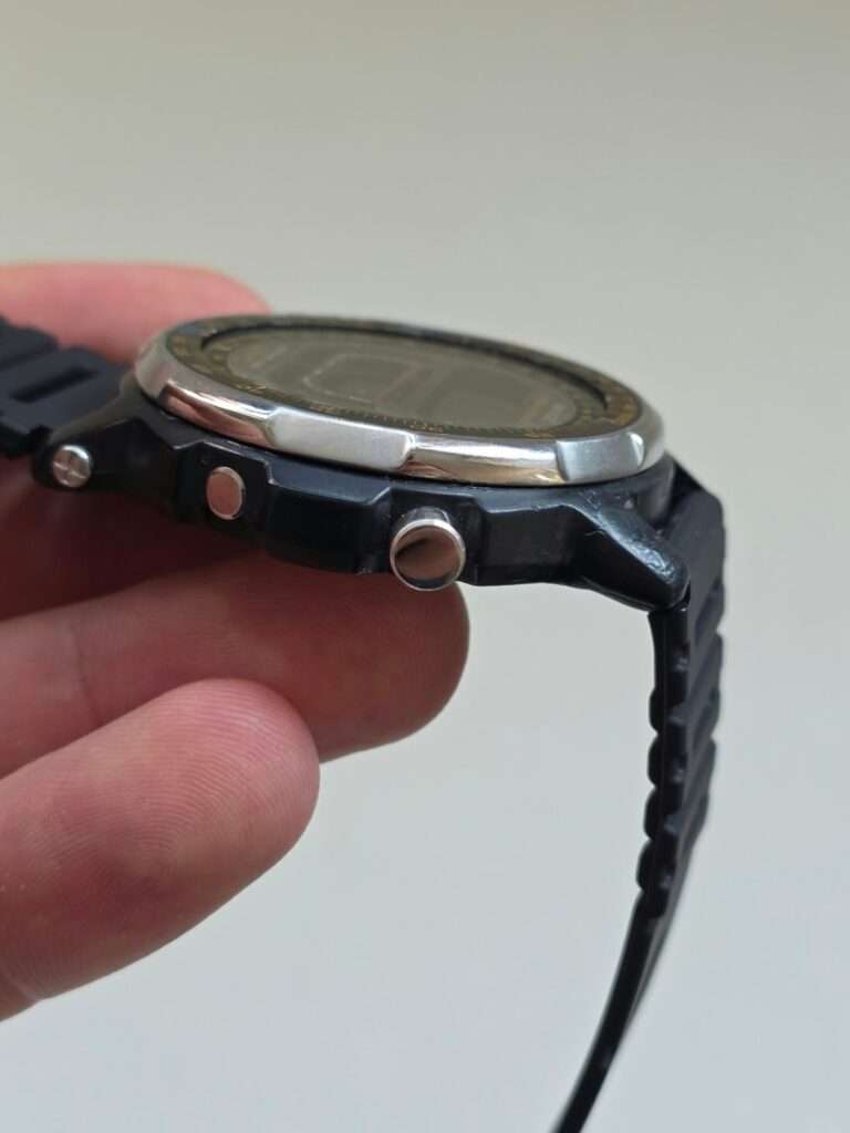Side profile of Casio DW-401 Sky Walker showing steel pushers, screws and repaired resin lug
