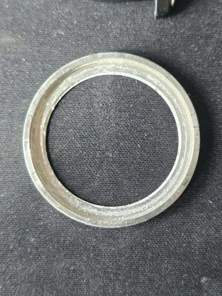Removed stainless steel bezel ring from Casio DW-401 Sky Walker lying on black fabric